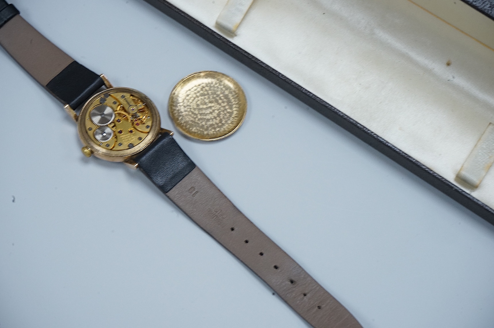 A gentleman's late 1940's 9ct gold Longines manual wind wrist watch, with Arabic dial and subsidiary seconds, case diameter 33mm, on a alter associated strap and buckle.